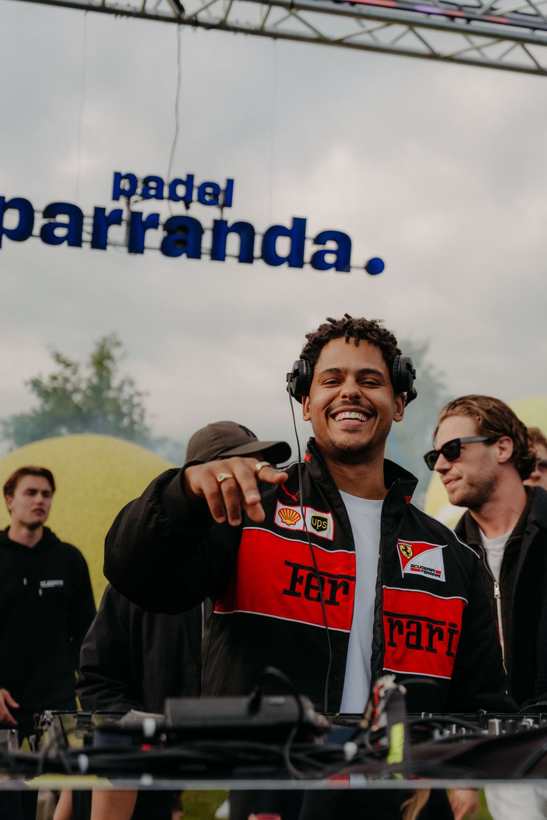 DJ in front of the Padel Parranda sign in Amsterdam