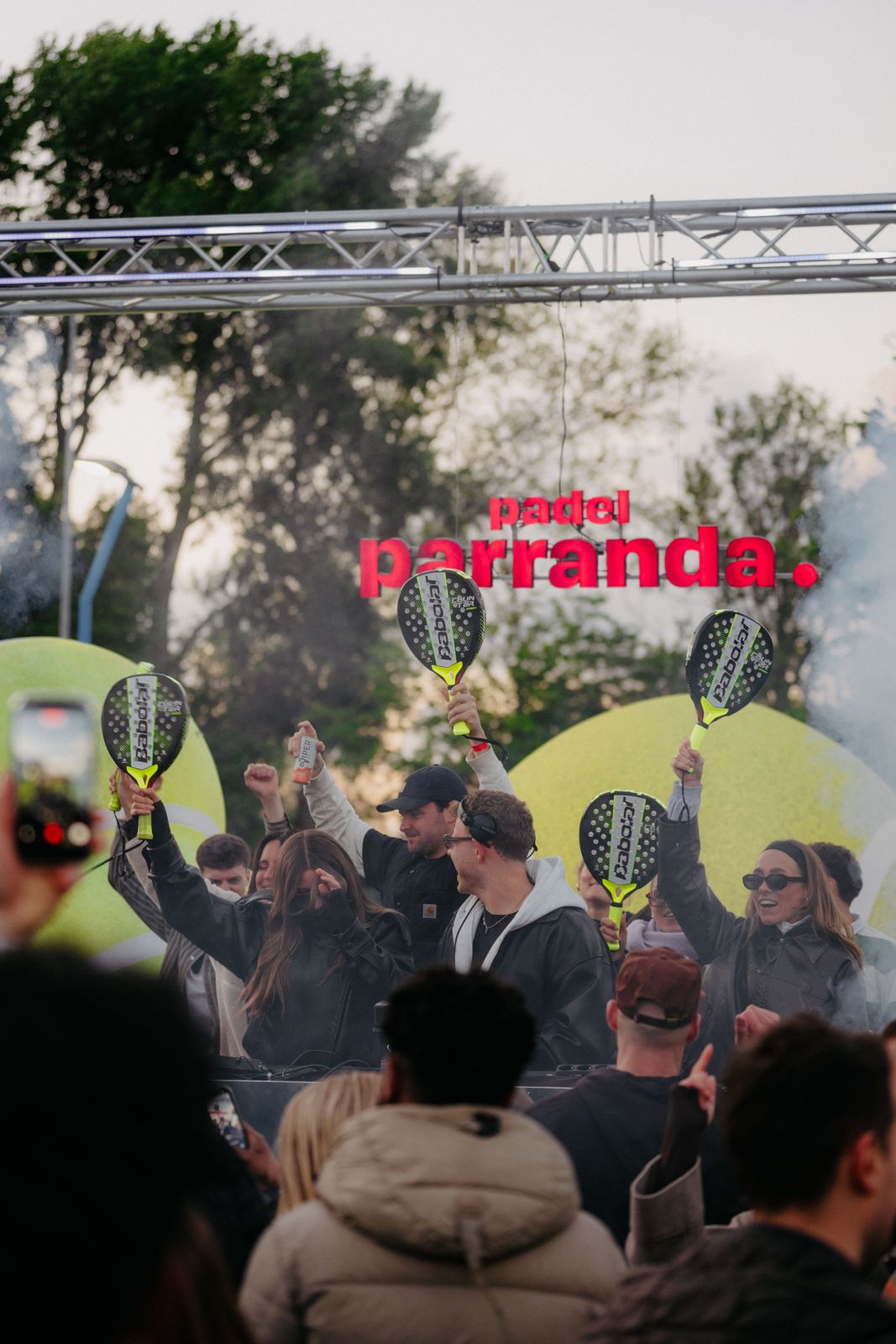 Crowd with racquets in the air under the Padel Parranda sign, Amsterdam