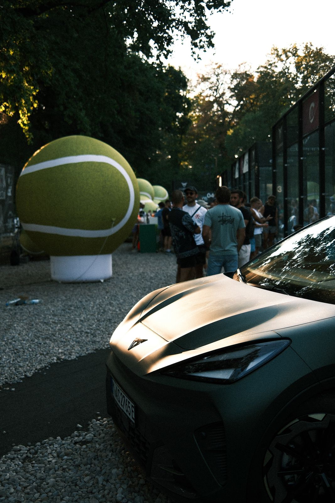 CUPRA on the podium next to the giant tennis ball and the court
