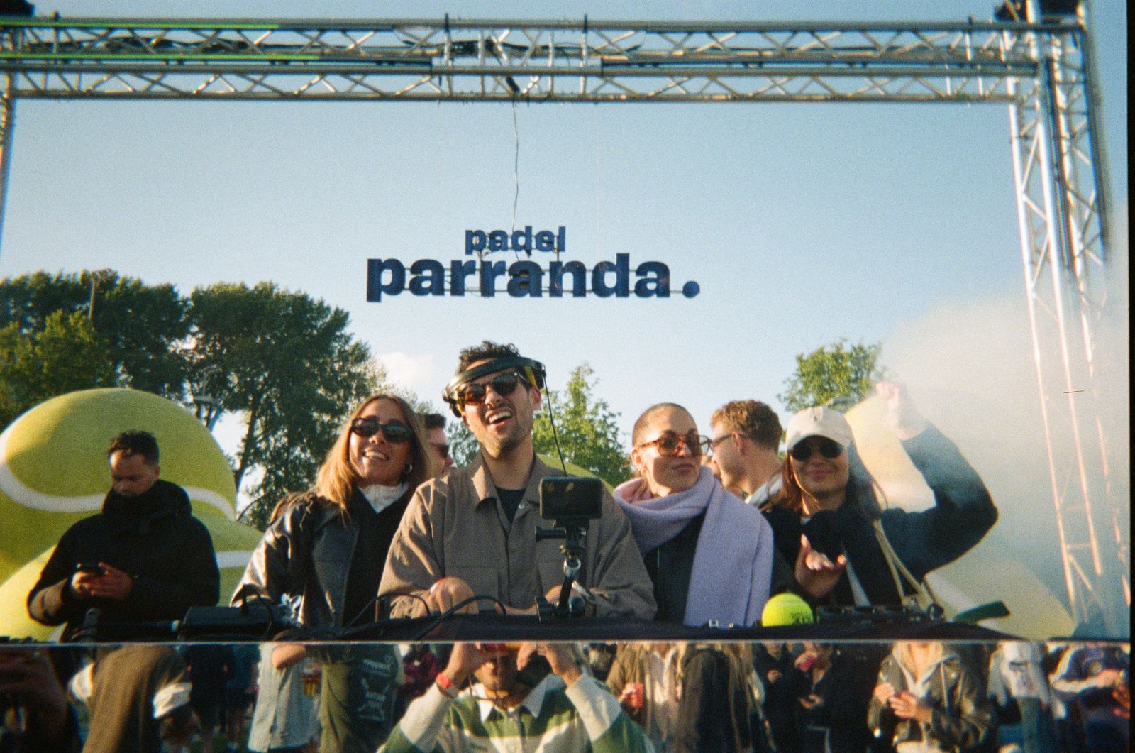 DJs under the Padel Parranda sign, shot on film