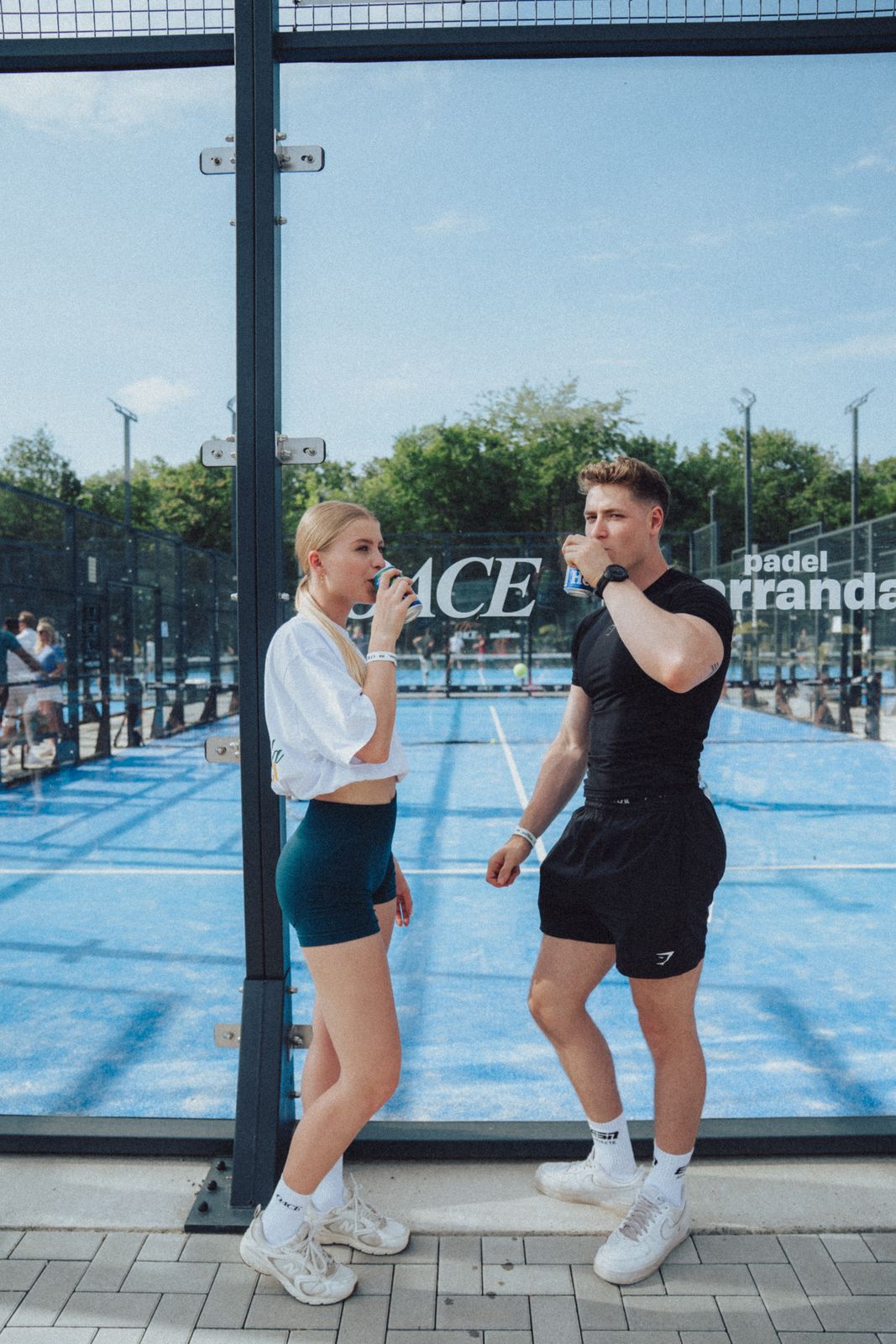 Two players in front of the OACE court sign in Frankfurt